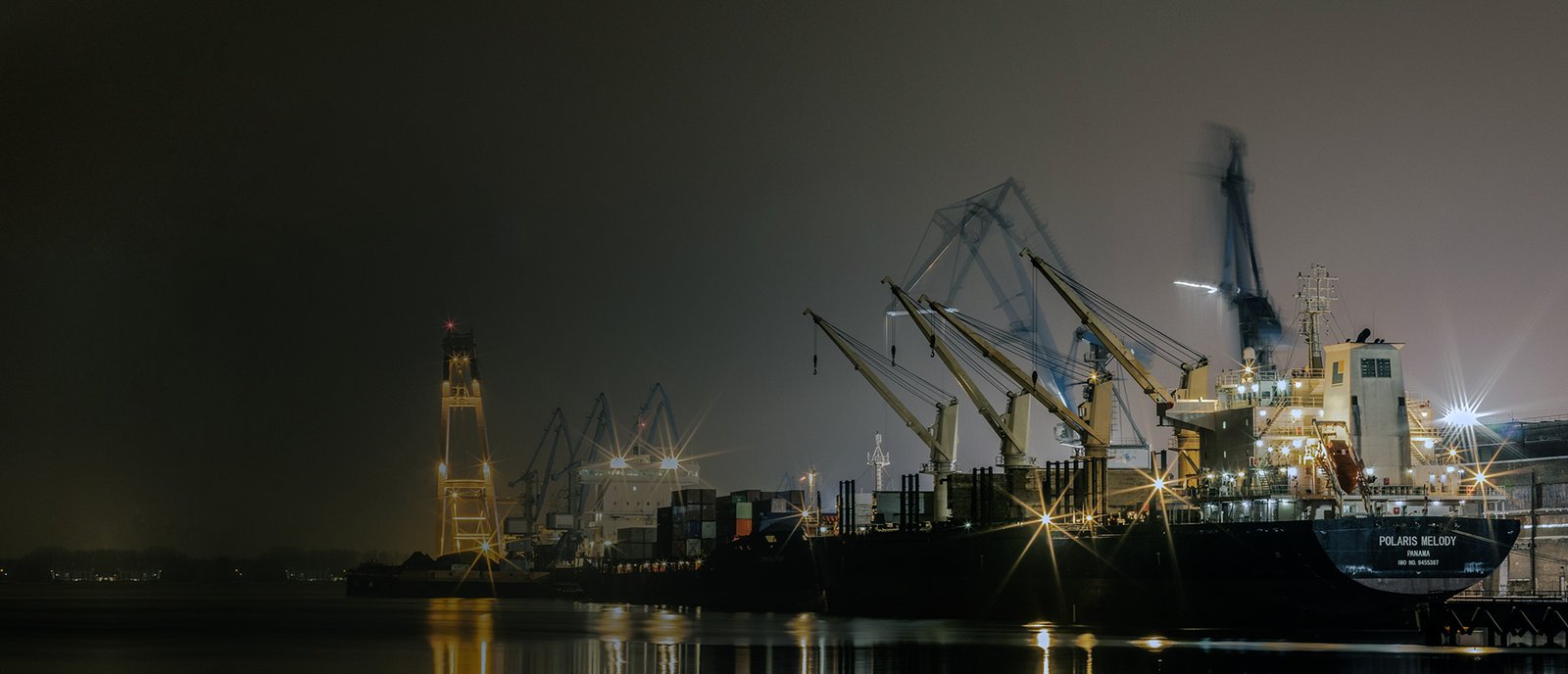 Container vessel alongside a port terminal at night